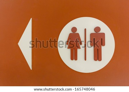dark orange sign of the restrooms