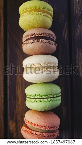 assortment of macaroon cookies on wooden surface