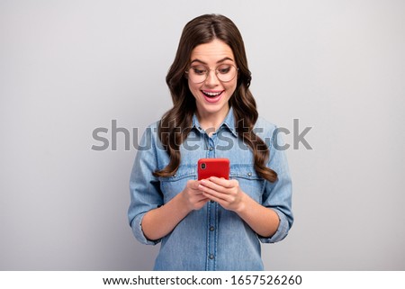 Photo of beautiful freelancer business lady hold browsing telephone check followers subscribers addicted user wear specs casual jeans denim shirt isolated grey color background