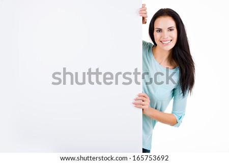 Happy smiling beautiful young woman showing blank signboard - isolated on white
