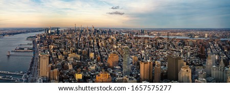 New York City Manhattan skyline panoramic aerial view with Hudson River at sunset. High resolution image made by different photos stitched together.