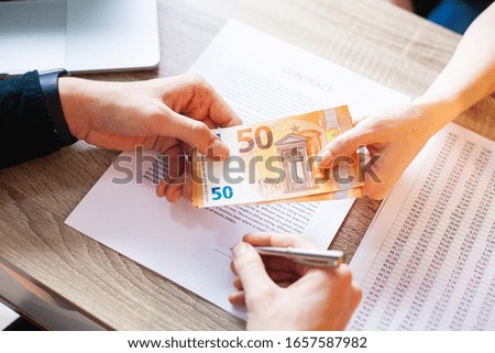 Businessman giving money while making deal to agreement a real estate contract and financial corporate