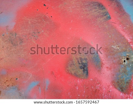 traces of layers of bright paint on a metal surface - abstract background