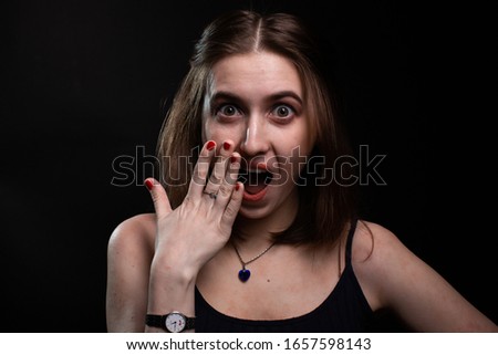 Girl shows emotion surprise holding red nails palm to face