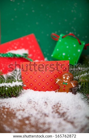 Christmas decoration arranged in different scenes.Gingerbread man in front of greeting card.
