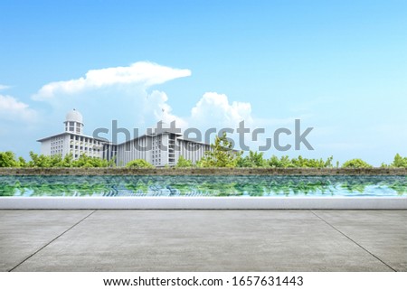 Pathway with pond and mosque view with a blue sky background. Jakarta, Indonesia Royalty-Free Stock Photo #1657631443