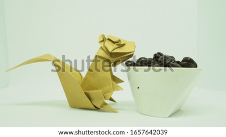 Squirrel and coffee beans folded on a piece of paper