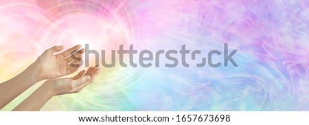 Healer working with colour healing full spectrum energy  - female cupped hands sensing  rainbow coloured vortex with  copy space 
 Royalty-Free Stock Photo #1657673698
