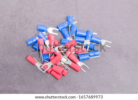 the pile of blue and red electrical joint for wires on gray background
