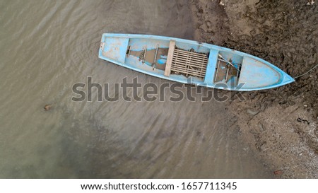 Lonely fishing boat on lake. Aerial photo, top view