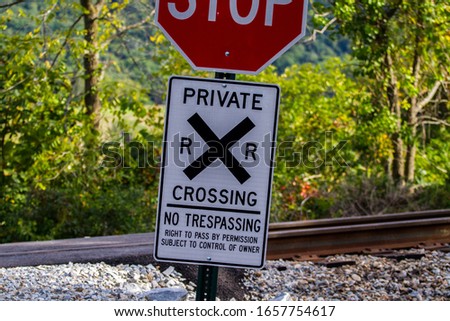 No Trespassing, Railroad Crossing Sign With Stop Sign On The Top.  