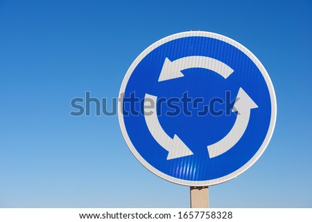 Roundabout traffic sign and clear sky in Spain.