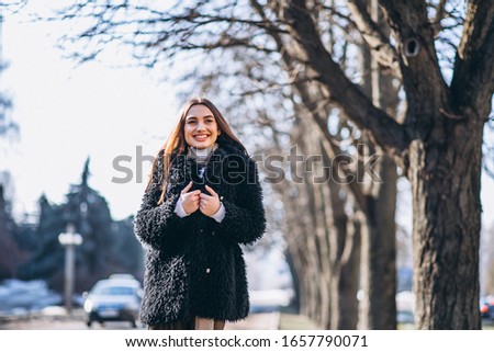 Pretty woman walking poutside in park