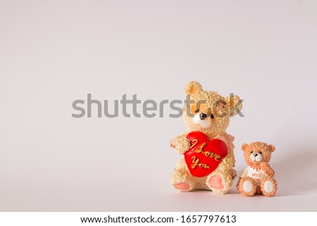 Two decorative ceramic bears holding quotes ``I love you`` and ``I miss you`` in quotes.Bears are in the lower right corner of the image