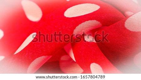 Background texture, decorative ornament, red polka dot fabric in white polka dots, round dots on fabric, shaped like or approximately like a circle or cylinder.