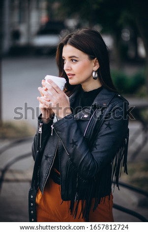 Young lady drinking coffee in the cold weather