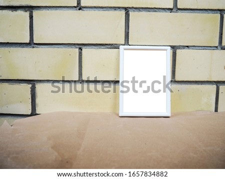 white frame on the background of a brick wall, mockup.