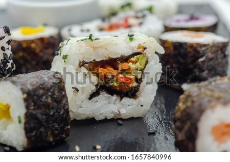 Mix veggie sushi and fish sushi on the black stone plate, japan food