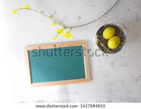 Easter concept picture with yellow flowers and eggs. Copy space for greeting, opening hours, menu or any inspirational message. Happy Easter Holiday!