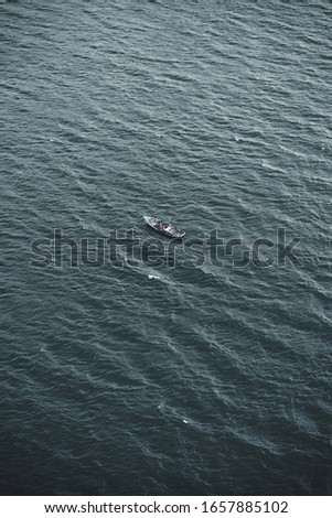 An aerial shot of a lonely fisherman boat in the vast sea right off the coast of Vietnam.