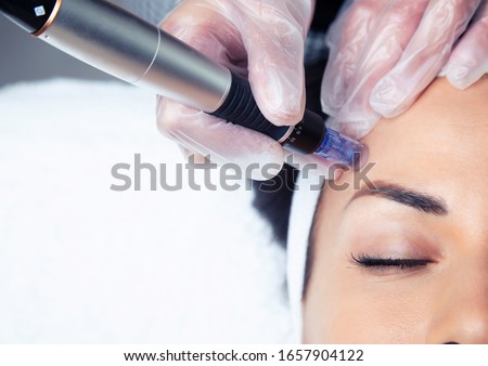 Shot of cosmetologist making mesotherapy injection with dermapen on face for rejuvenation on the spa center. Royalty-Free Stock Photo #1657904122