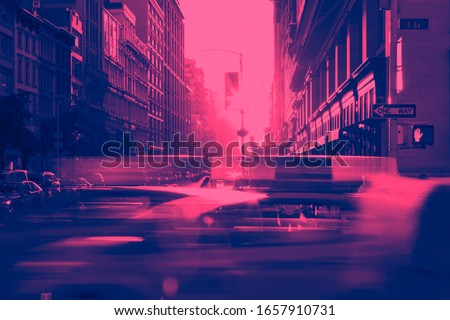 New York City taxi cabs speeding through Midtown Manhattan with pink and blue duotone color effect Royalty-Free Stock Photo #1657910731