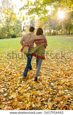 Couple walking outdoors in autumn