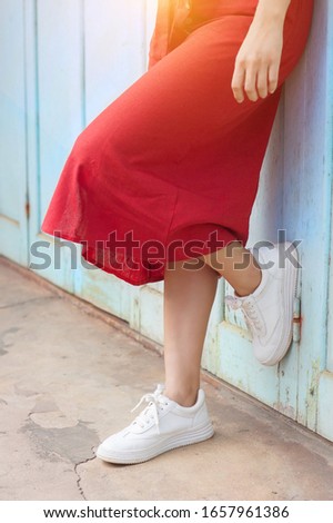 
Woman leaning on the blue wooden door