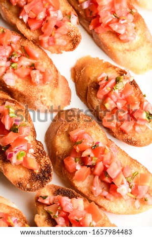 Bruschetta. French baguettes, sliced, toasted, drizzled with olive oil and topped with diced heirloom tomatoes, basil, capers and cheese. A classic French appetizer or amuse bouche’
