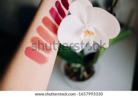Swatch of bright lipsticks on the girl's hand