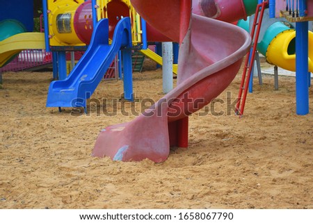 colorful empty children's playground in a park in the city. sliders in the sand. Royalty-Free Stock Photo #1658067790