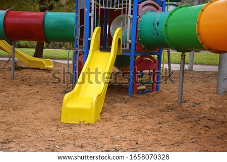 colorful empty children's playground in a park in the city. sliders in the sand. Royalty-Free Stock Photo #1658070328