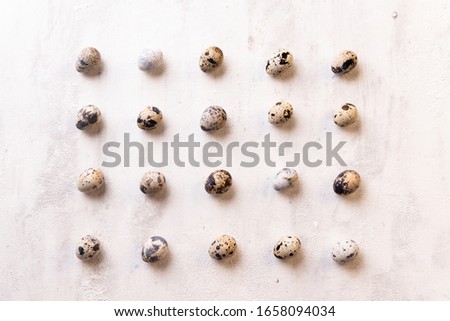 Pattern of quail eggs on a light background.Suitable for Easter pictures.