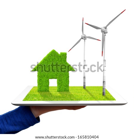 hand holding a tablet with green house and wind turbines