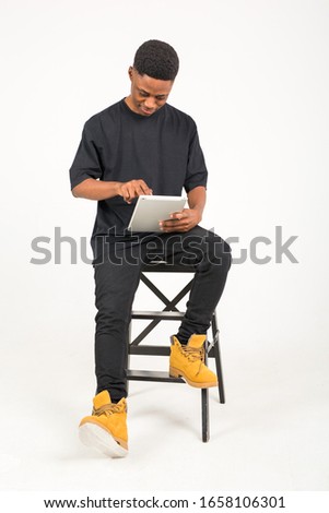 handsome young african man with a tablet in his hand on a white background