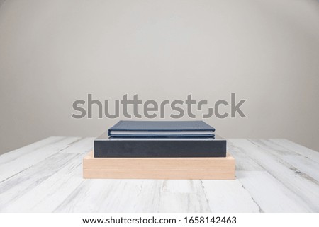 Stack of 3 albums books on isolated white blurred background with blank empty room space for text or copy.