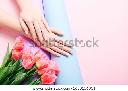 Beautiful woman manicure on creative trendy pink background. Minimalist manicure trend. Top view, flat lay. Copy space for your text.
