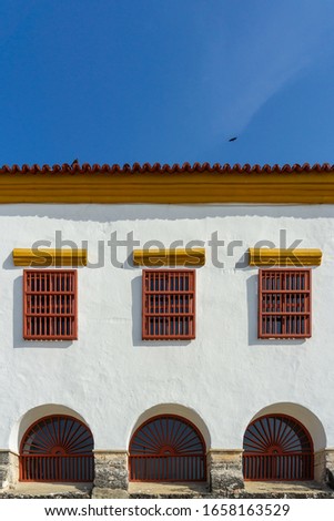 Facade detail of Museum of Colombian Navy history with colonial style windows in Cartagena, Colombia.