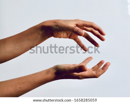 Two female hands holding a space