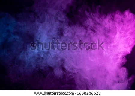 close up of colorful  blue and pink steam smoke in mystical and fabulous forms on black background.Mocap for art
