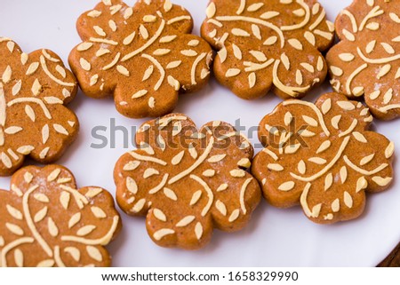Ginger fragrant cookies in the form of flowers. Delicious cookies with orange juice on a wooden table.