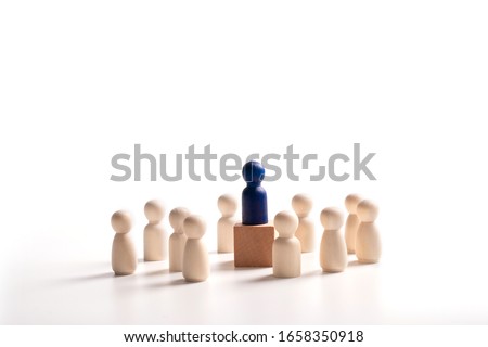 Wooden figure standing on the box for show influence and empowerment. Concept of business leadership for leader team, successful competition winner and Leader with influence Royalty-Free Stock Photo #1658350918