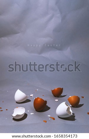 Easter egg, eggshell on vertical gray background with copyspace. Banner of macro moody minimalistic decoration concept. Stock photo.