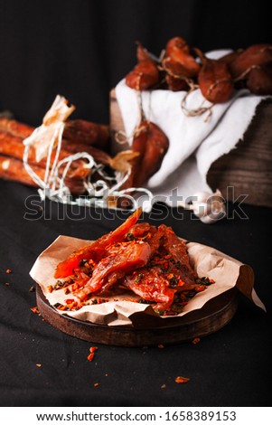 Selection of smoked meats sausages decorated with garlic and pepper. Spanish Dry Cured Pork Sausage. Meat On A Plate During Barbecue. Sausage, Brisket.