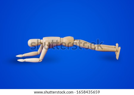 Sports wooden toy figure on blue background