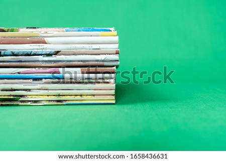 Stack magazines on green background