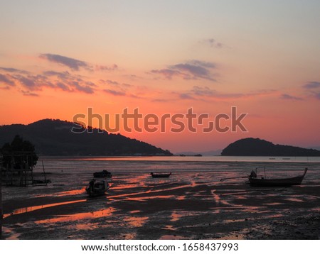 Scenic of low tide sea while sunset against orange sky , Koh yao , Thailand