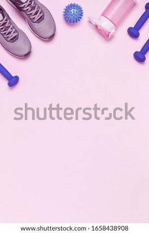 Sports equipment and shoes for women's training. Pink background, vertical picture.