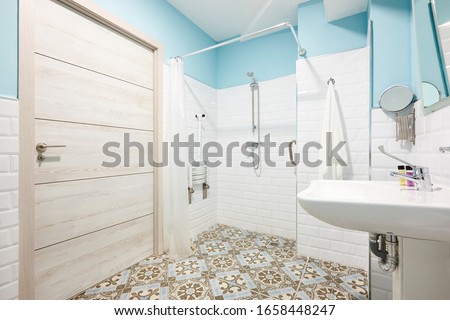 Decorated bathroom adapted for disabled people. Contemporany accessibility indoor architecture Royalty-Free Stock Photo #1658448247