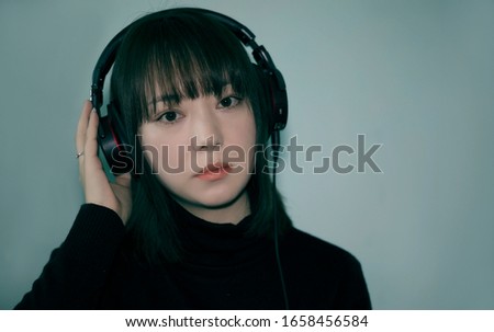 Beautiful Asian women wearing earphones
